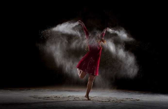 Young woman between fog in darkness