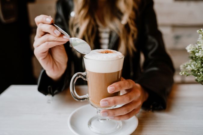 Woman drinking coffee from a glass