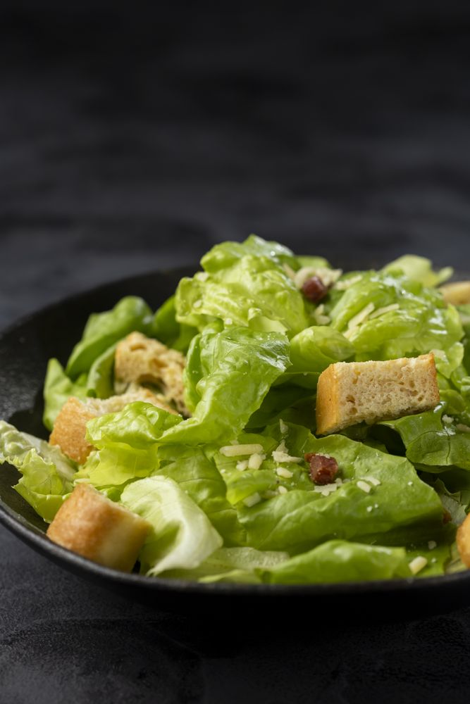 Caesar salad with croutons and bacon.