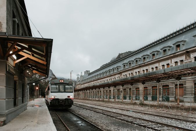 Train in railway station between hills