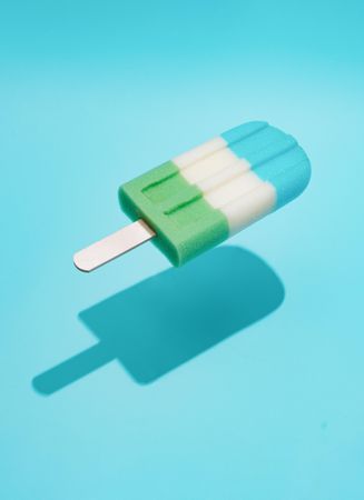 Colorful ice cream popsicle on bright blue background