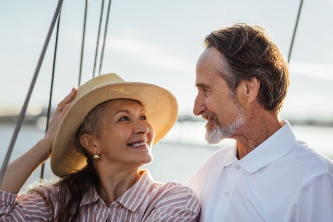 Happy older couple looking at each other on a sailboat