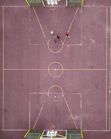 Aerial view of people playing in basketball court
