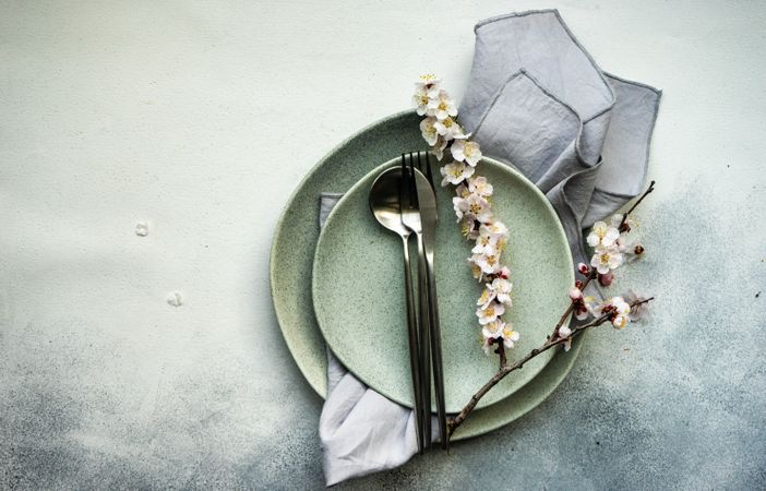 Top view of table setting of apricot blossom branches on elegant ceramic plates