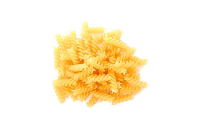 Pasta isolated on light background, top view. Traditional shape of dry uncooked whole pasta