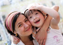 Two sisters embracing outside