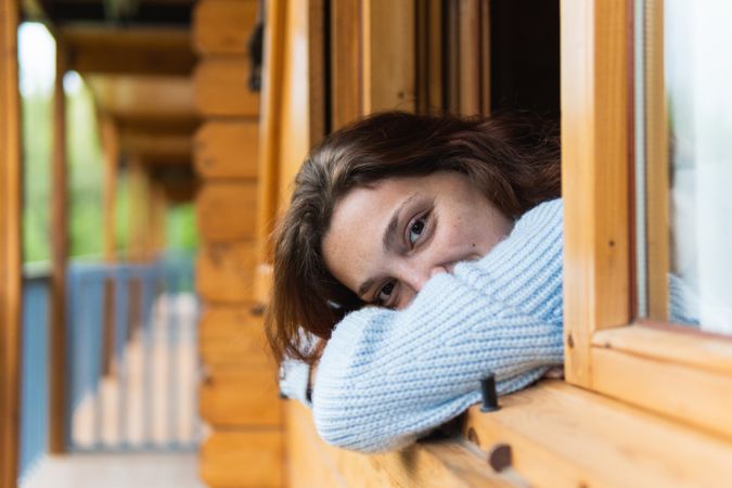Serene woman relaxing on terrace of house in countryside