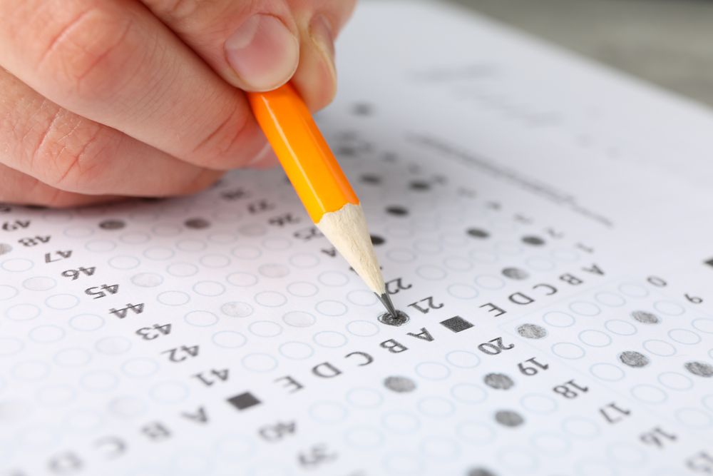 Close up of hand pencilling in multiple-choice test