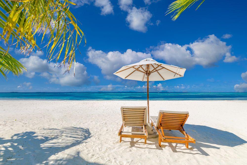 Two reclining chairs with a beautiful view of the ocean