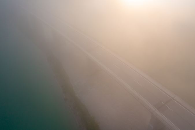Drone image at sunrise with Sylvenstein Bridge covered in fog