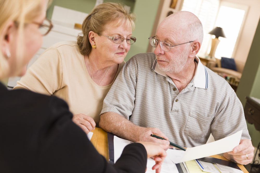 Adult Couple Going Over Papers in Their Home with Agent