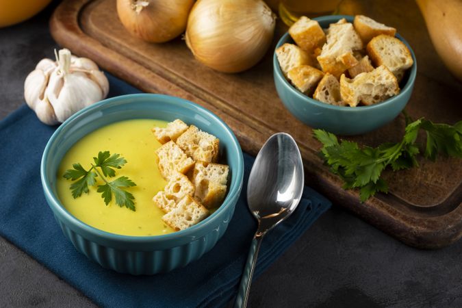 Bowl with onion soup and croutons on the table.