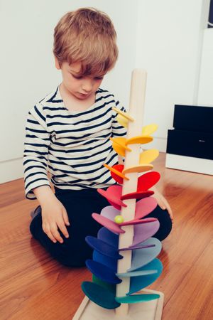 Boy playing with wooden construction pieces