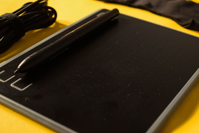 Close up of digital tablet on yellow table