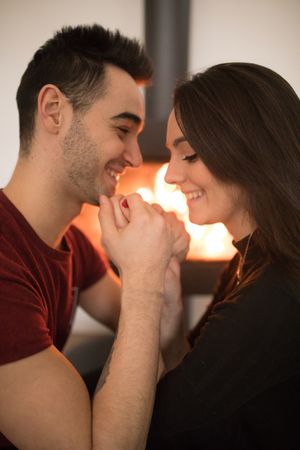 Couple sitting near fireplace