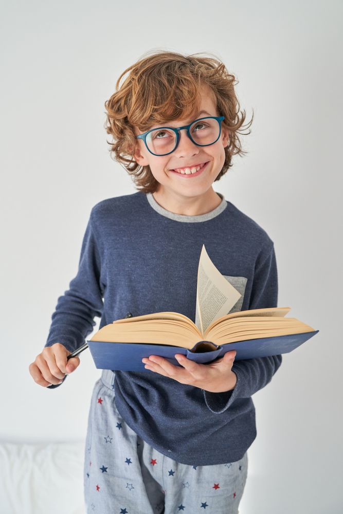 Smiling boy with open book