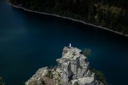 Religious statue of Virgin Mary overlooking a lake