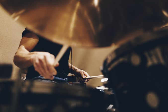 Man with headphones playing on drums