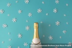 Bottle of sparkling wine on blue background with snowflakes 4AVz6b