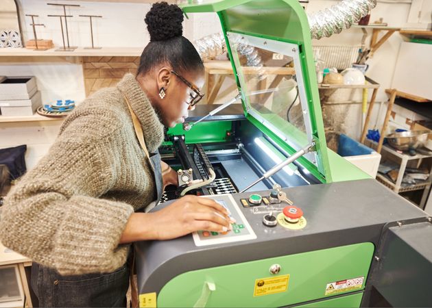 Black woman at a laser cutting