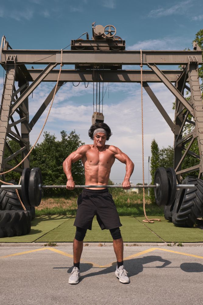 male with barbell in outdoor gym