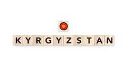 Wooden blocks bearing the name and flag of Kyrgyzstan. Kyrgyz and Asian Culture, national identity, travel, and geography in a copy space design.