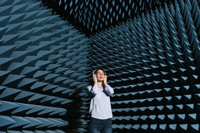 Woman in sound room listening to music
