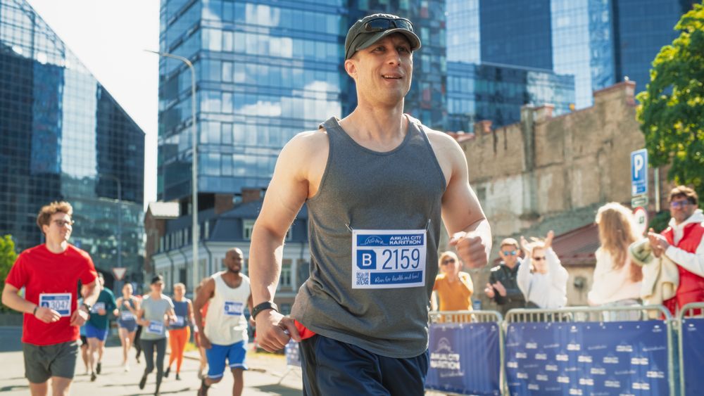 Friendly Happy Male Runner Celebrating Crossing the Finish Line in a Race