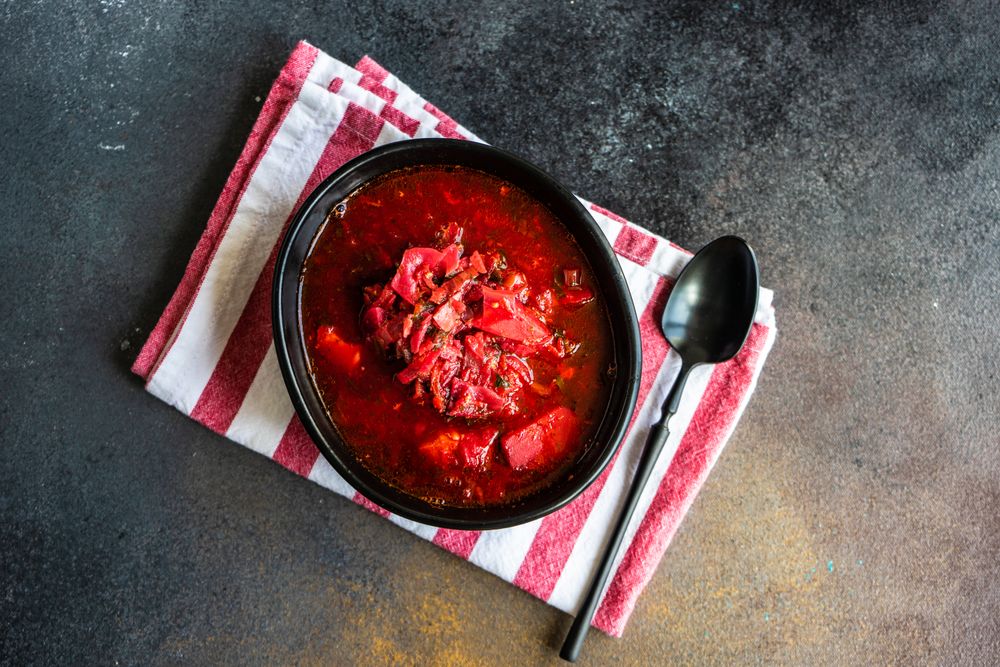 Ukrainian beetroot soup borscht on striped napkin