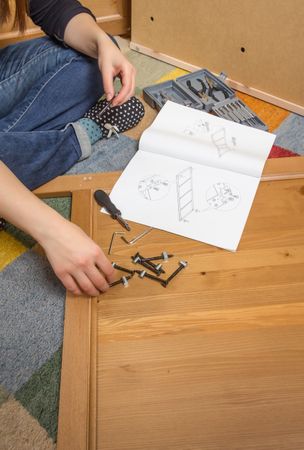 Woman with tools ready to assemble furniture