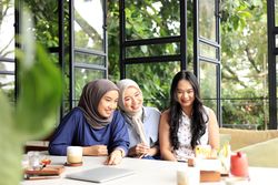 Asian Female Friends are Enjoying Eating, Drinking, and Hanging Out at a Restaurant or Cafe