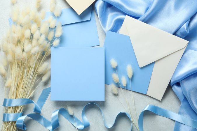 Light blue square paper surrounded with willow and an envelope