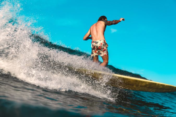 Man on surf board on waving water