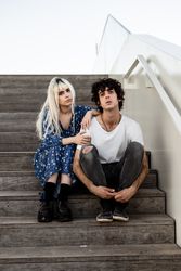 Happy couple sitting on wooden stair