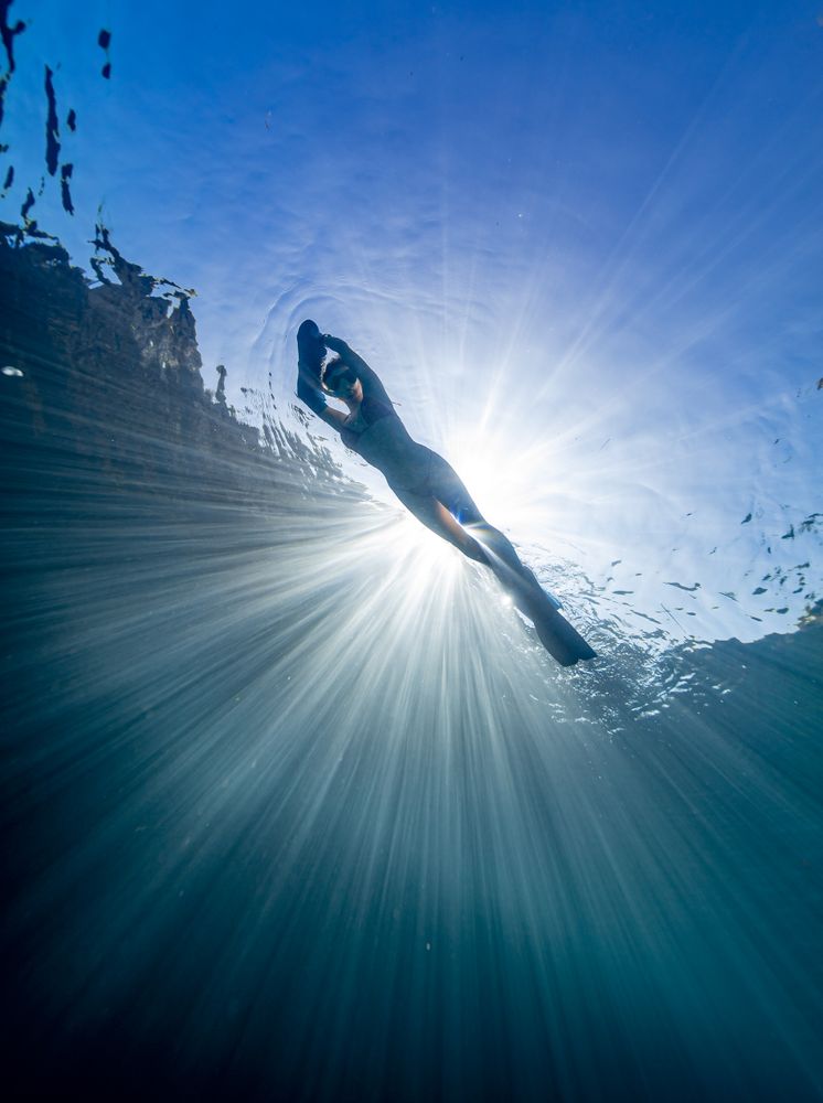 Woman swimming on the surface of water