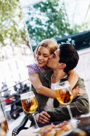 Happy young couple drinking beverages outdoors
