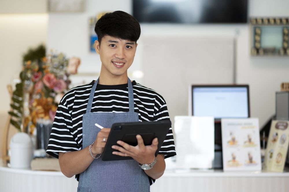 Barista serving in coffee shop, taking customer orders, coffee shop owner.
