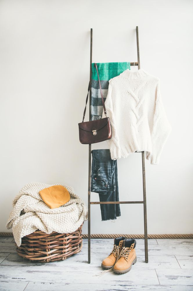 Woolen sweater, checked scarf, jeans, boots, shoulder bag and knitted hat, copy space