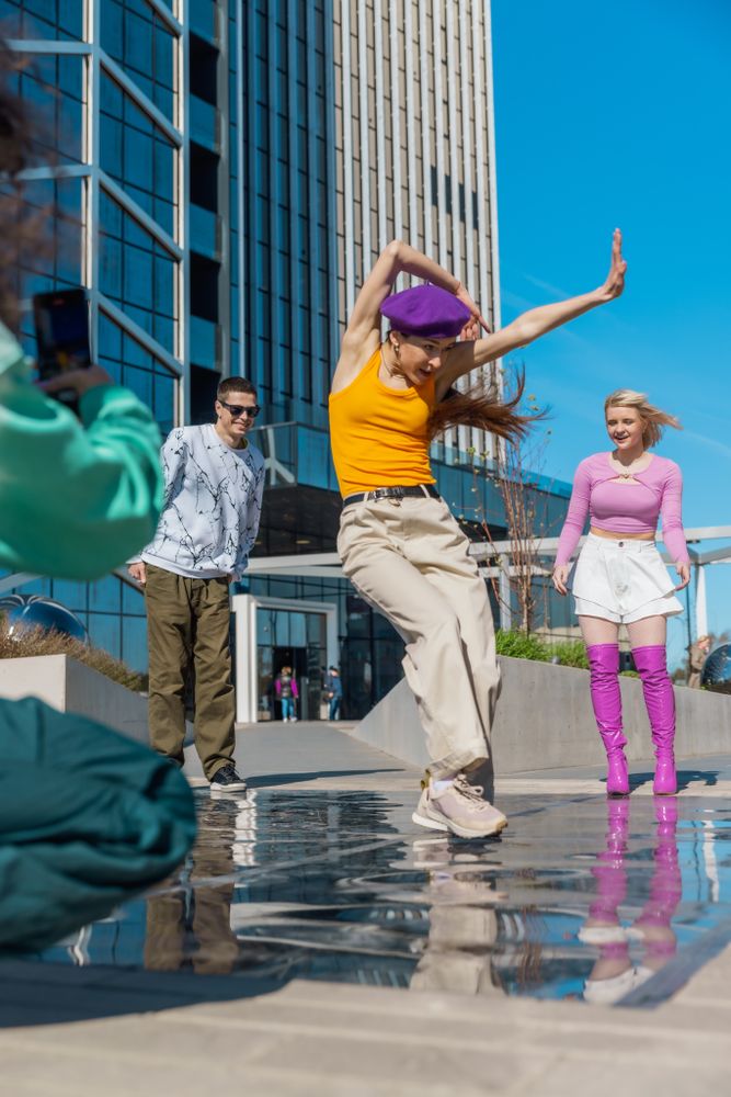 Vertical Screen: Young And Stylish Female Hip Hop Dancer Freestyling On City Street In Circle Of Trendy Friends.