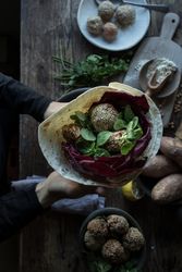 Hands with fresh sweet potato falafel