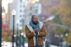 Man wearing jacket walking in street