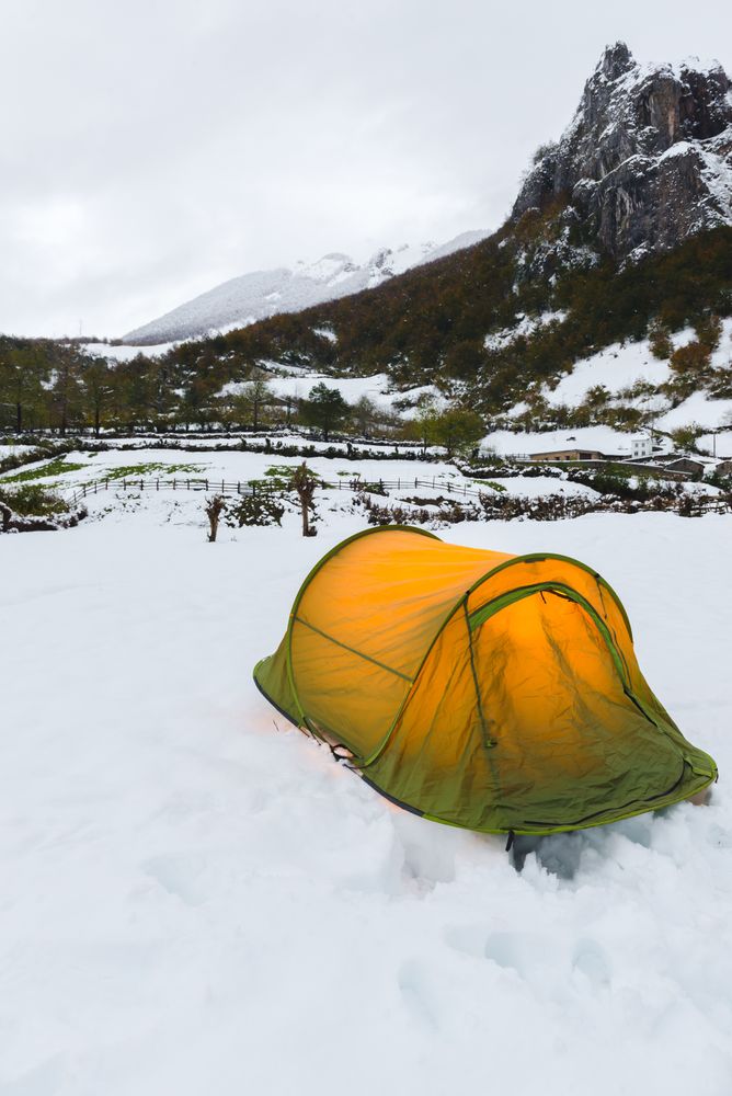 Tourist tent in mountains on snow