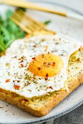 Delicious breakfast of fried eggs with toast and salad.