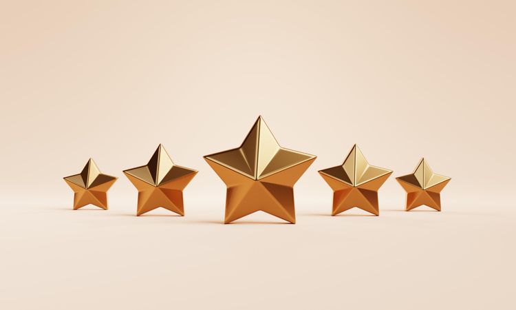 Gold star ornaments on beige background