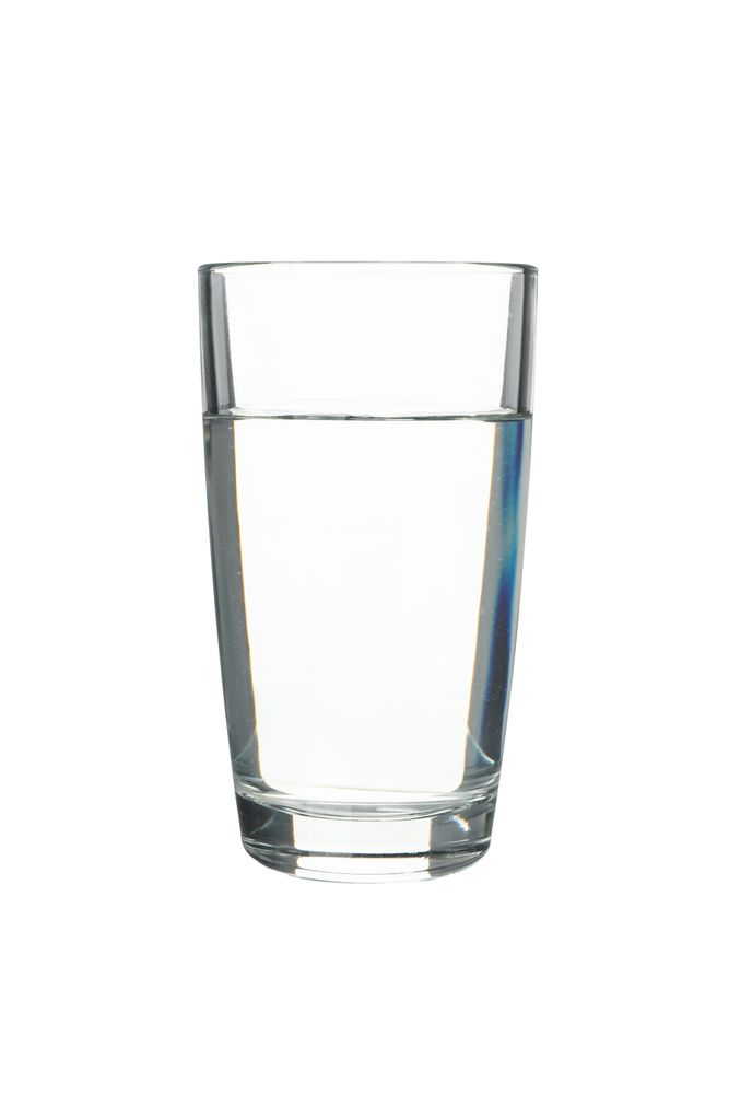 Tall glass of water in plain room