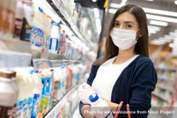 Woman grocery shopping in surgical mask 4N1me5
