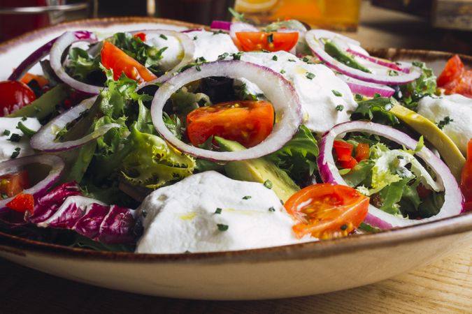 Vegetables salad with onion greens and cream sauce