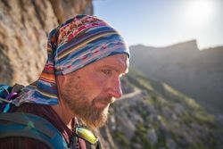 Mature male traveler with backpack in mountains