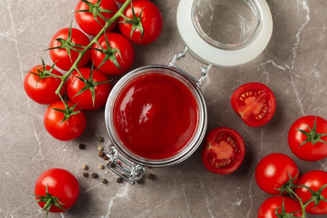 Composition with tomatoes on gray background. Ripe vegetable