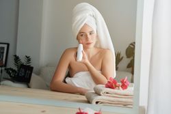 Female using blackhead remover during skin care procedure